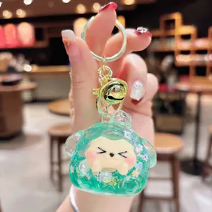 Cute quicksand glitter cartoon monster keychain, green liquid resin toy pendant for bags.