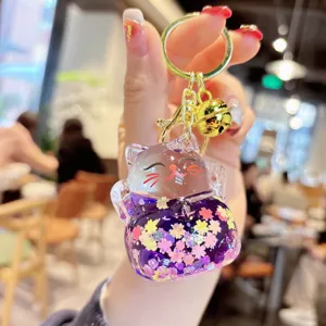 Transparent liquid quicksand lucky cat keychain with cute glitter and gold ring for bag charm.