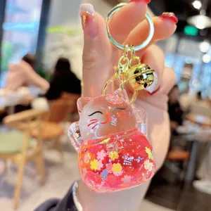 Clear liquid quicksand lucky cat keychain with floral glitter and gold ring for bag and car.