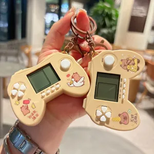 Detailed view of cute capybara handheld game console keychain, portable mini toy pendant.