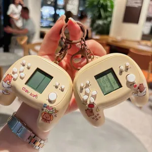 Detailed view of the cute capybara handheld game console keychain, fun decompression toy pendant.
