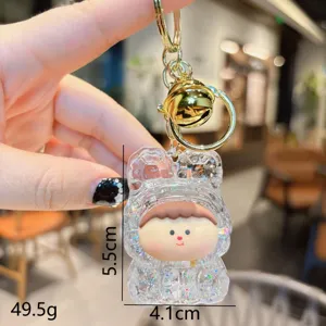 Acrylic quicksand keychain pendant detail, clear glitter blind box toy charm with gold ring.