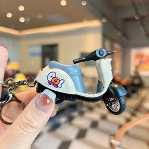 Cute alloy scooter keychain detail shot, creative miniature motorcycle pendant for keys and bags.