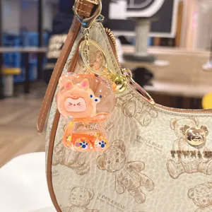 Cute liquid quicksand bear keychain charm for backpack, stylish glitter acrylic bag pendant.