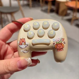 Detailed close-up shot of a cute capybara themed mini game controller keychain toy.