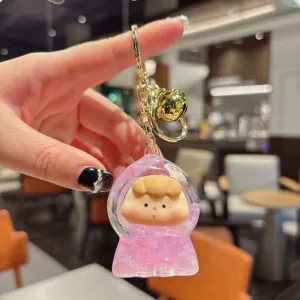 Cute liquid quicksand keychain with cute cartoon doll and glitter, perfect bag charm accessory.