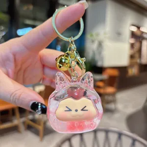 Portachiavi con sabbia mobile liquida e ciondolo mostro carino con campanello d'oro.