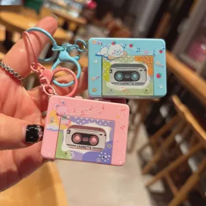 Detailed view of lovely cartoon cassette player keychain, cute pink and blue bag charm toy.