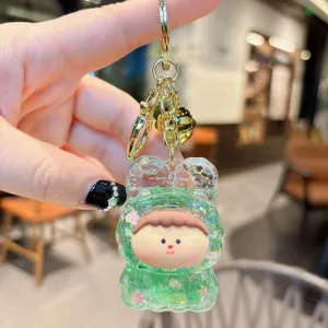 Cute acrylic quicksand keychain pendant, green cartoon character charm for bags and keys.