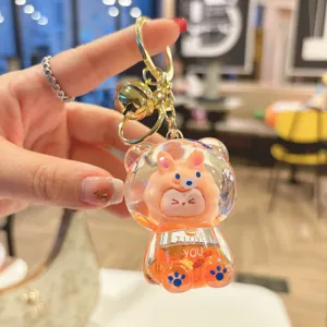 Cute liquid quicksand KIKI bear keychain pendant for women bags, stylish gift and accessory.