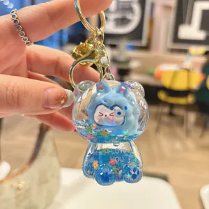 Close-up detail of the cute liquid quicksand bear keychain with sparkly glitter and blue charm.
