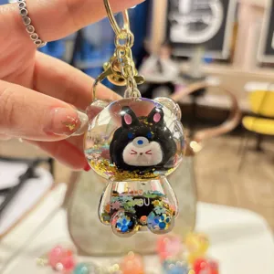 Cute cartoon quicksand flash KIKI bear keychain, sparkling liquid bag pendant for daily use.