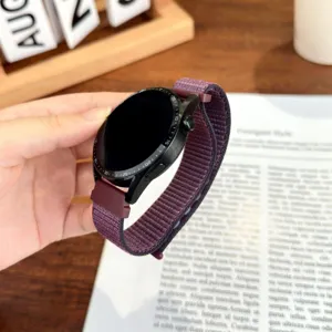 Vista dettagliata del cinturino smartwatch in nylon viola scuro con trama tessuta resistente.