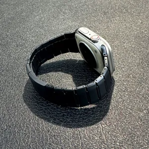 Stainless steel link watch strap compatible with Apple Watch, premium black metal band replacement.