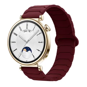 Detail view of a stylish gold smartwatch with a dark red magnetic silicone watch strap replacement.