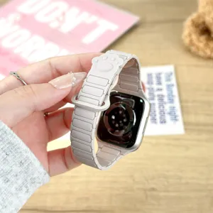 Silicone magnetic watch strap detail shot, cute paw print design, flexible replacement band.