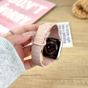 Pink silicone magnetic watch strap for Apple Watch with cute paw design, comfortable wear.
