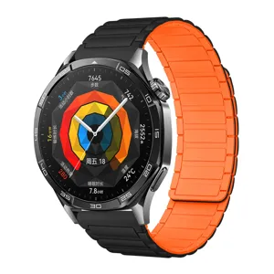 Closeup of smart watch with black metallic case and vibrant orange magnetic silicone strap UI.