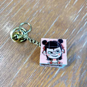 Cute cartoon Nezha mini Rubik cube keychain with metal ring and bell bag pendant charm.