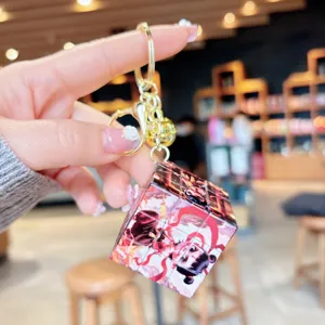 Close-up detail of the Chinese cartoon character Nezha Rubik's cube keychain pendant.