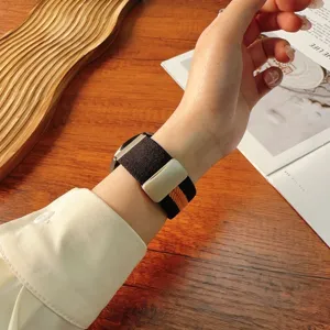 Detailed view of the striped woven nylon watch band with a secure magnetic folding clasp.