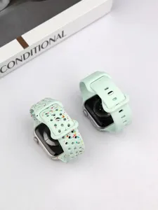 Detailed view of mint green silicone watch band with colorful speckle design, breathable holes.