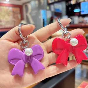 Korean style sweet pearl acrylic bow keychain sweet cute headphone bag pendant charm accessory.