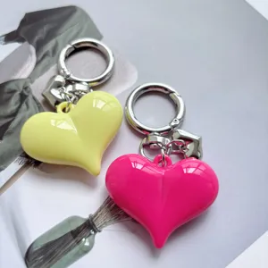 Candy colored heart alloy keychain detail, cute bag pendant and car key ring accessory.