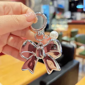 Korean sweet silver bow keychain with pearl pendant, exquisite metal bag pendant accessory.