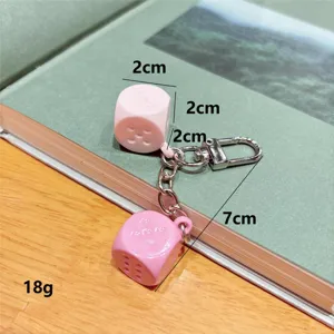 Cute pink dice keychain for bags and keys, fun bar game accessory and charming gift pendant.