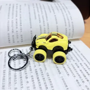 Detail view of the yellow monster truck keychain with metal ring and alloy car toy model.