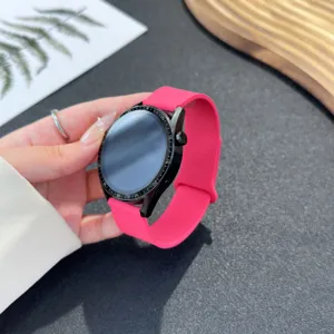 Bright pink silicone replacement watch strap compatible with smartwatches, soft and flexible band.