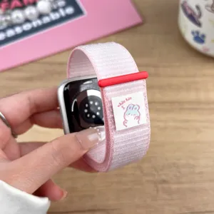Nylon loop watch strap compatible with Apple Watch, featuring pink design and cute bunny woven label.