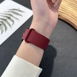Dark red silicone magnetic watch band detail shot, showcasing the soft strap and smooth texture.