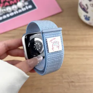 Blue nylon velcro watch band compatible with Apple Watch, soft elastic loop with cute label.