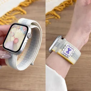 Nylon loop strap for Apple Watch with velcro and cute purple bow woven label detail.