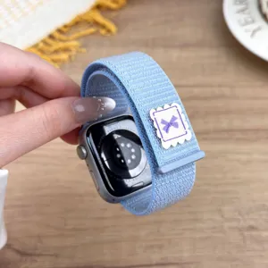 Blue nylon loop watch strap detail featuring a cute purple bow accent for smartwatches.