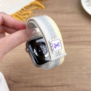 Nylon loop watch strap with purple bow detail for Apple Watch, comfortable daily replacement.
