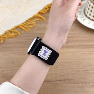 Nylon loop watch band detail shot, showing the black strap with cute bow embroidery patch.