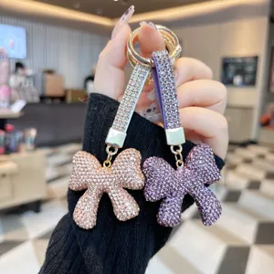 Rhinestone bow keychain, sparkling crystal bag charm and stylish car key ring accessory.