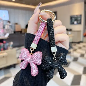 Sparkling rhinestone bow keychain, luxury bag charm and stylish car key holder for women.