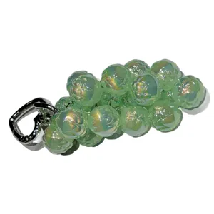 Exquisite acrylic green beaded fruit bag pendant cute keychain phone charm accessory.