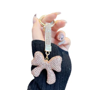 Sparkly rhinestone bow keychain and stylish bag charm for car keys and accessories.