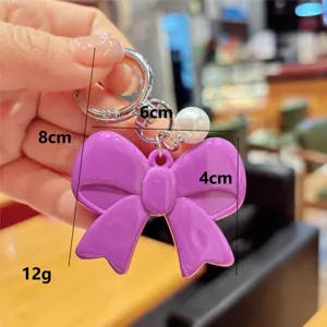 Korean style sweet purple bow keychain with pearl pendant and metal ring accessory.