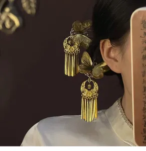 Close-up of Chinese style elegant gold butterfly hair fork with delicate tassels detail.