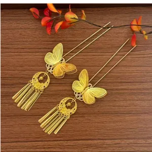 Close-up of exquisite traditional Chinese golden butterfly hairpins with delicate metal tassels.