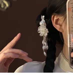 Close-up detail of elegant pearl tassel hair clip, showing exquisite metal and pearl craftsmanship.