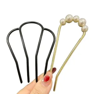 U-shaped pearl hair pin and black multi-prong comb set for elegant bun styling and secure hair hold.