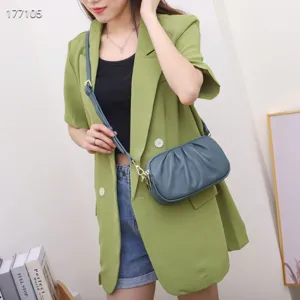 Detailed view of genuine leather women's soft gathered crossbody bag with multiple zippers.