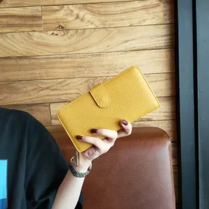 Yellow long leather wallet for women with snap closure and multiple card slots detail view